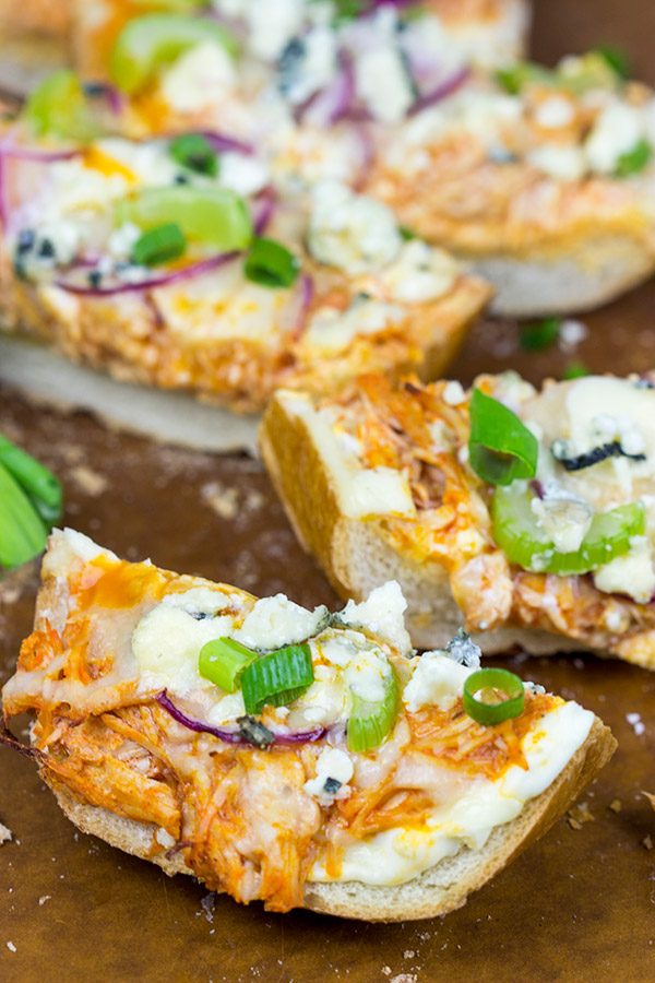 These Buffalo Chicken Breadsticks make an excellent football appetizer! Grab a loaf of French bread and top it with spicy buffalo chicken, creamy blue cheese and melty mozzarella!