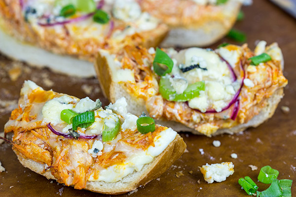 These Buffalo Chicken Breadsticks make an excellent football appetizer! Grab a loaf of French bread and top it with spicy buffalo chicken, creamy blue cheese and melty mozzarella!
