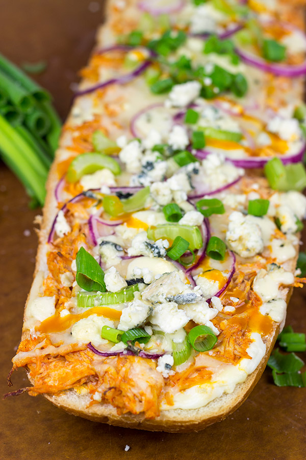 These Buffalo Chicken Breadsticks make an excellent football appetizer!  Grab a loaf of French bread and top it with spicy buffalo chicken, creamy blue cheese and melty mozzarella!