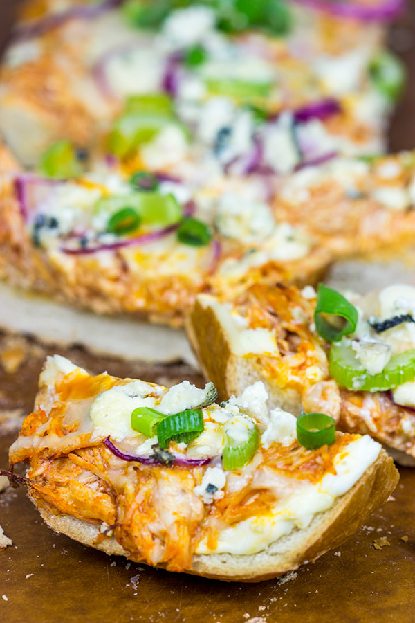 These Buffalo Chicken Breadsticks make an excellent football appetizer! Grab a loaf of French bread and top it with spicy buffalo chicken, creamy blue cheese and melty mozzarella!