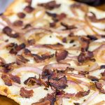 Flammkuchen, or tarte flambée in French, is a German-style thin-crust "pizza" topped with bacon and onions...and it's delicious!