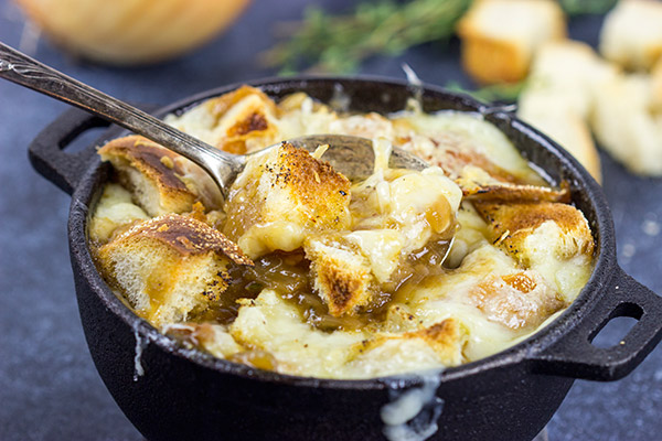This classic French Onion Soup includes flavorful broth topped with toasted sourdough croutons and plenty of melted cheese!  It's the perfect fare for cold winter evenings!