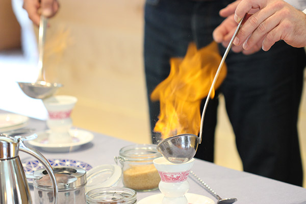 Rüdesheim Coffee is a unique German coffee cocktail featuring flambeed sweetened brandy topped with strong coffee, whipped cream and shaved chocolate.