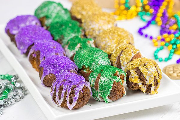 Let the good times roll with a batch of these Mardi Gras Donut Holes!