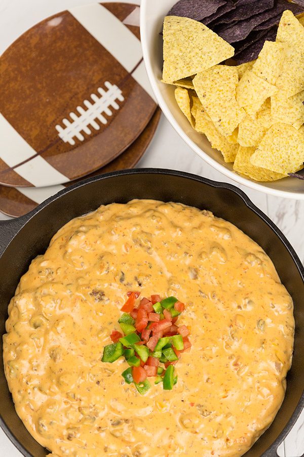 This Cheesy Skillet Queso Dip is an easy and tasty appetizer recipe, and it's perfect for watching college bowl season and playoff football games!