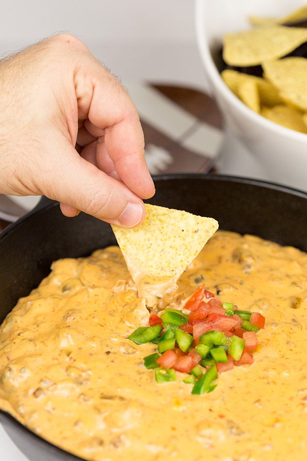 This Cheesy Skillet Queso Dip is an easy and tasty appetizer recipe, and it's perfect for watching college bowl season and playoff football games!