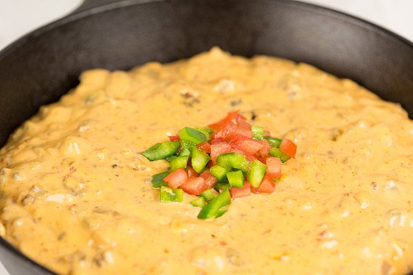 This Cheesy Skillet Queso Dip is an easy and tasty appetizer recipe, and it's perfect for watching college bowl season and playoff football games!