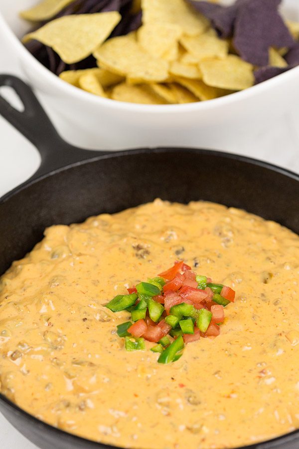 This Cheesy Skillet Queso Dip is an easy and tasty appetizer recipe, and it's perfect for watching college bowl season and playoff football games!