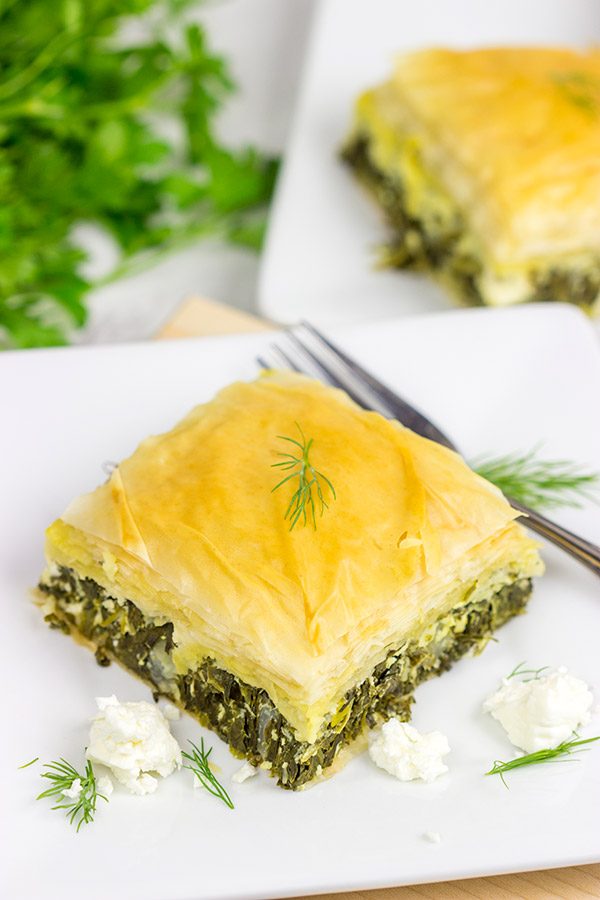Spanakopita is a classic Greek recipe featuring layers of flaky dough stuffed with spinach and feta cheese...and it's delicious!