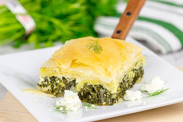 Spanakopita is a classic Greek recipe featuring layers of flaky dough stuffed with spinach and feta cheese...and it's delicious!