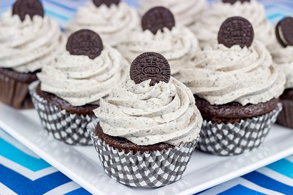 A moist chocolate cake and a cookies 'n' cream frosting combine to create these tasty Oreo Cupcakes!
