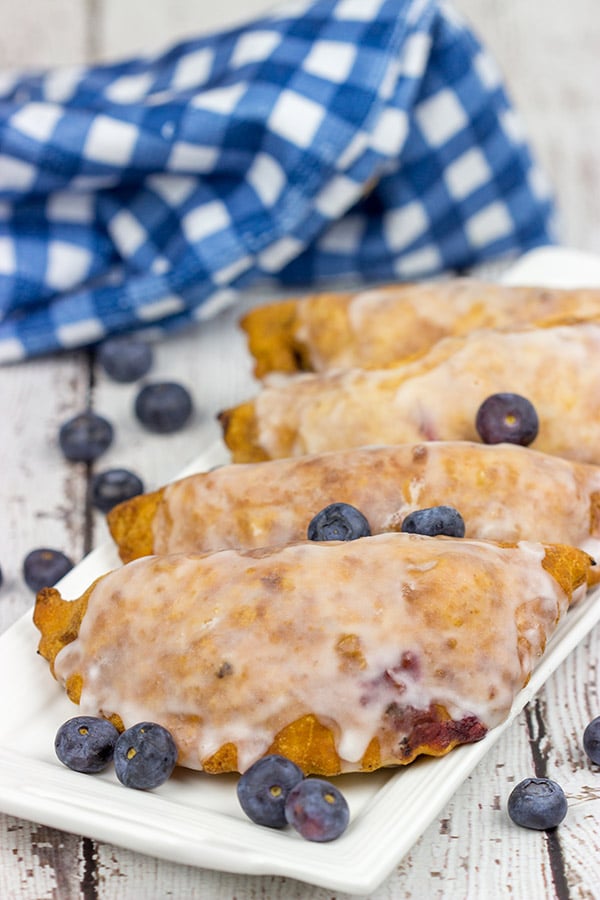 Filled with fresh blueberries and a hint of lemon zest, these Glazed Blueberry Hand Pies are the perfect dessert for warm summer days!