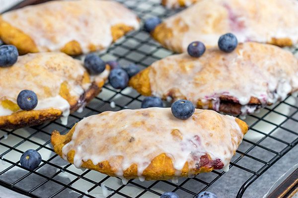 Filled with fresh blueberries and a hint of lemon zest, these Glazed Blueberry Hand Pies are the perfect dessert for warm summer days!