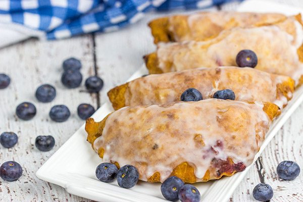 Filled with fresh blueberries and a hint of lemon zest, these Glazed Blueberry Hand Pies are the perfect dessert for warm summer days!