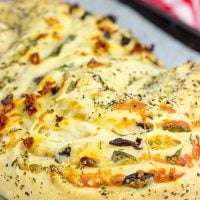 This Stuffed Italian Bread is so much fun to make...and even more fun to eat! It's packed with mozzarella, Parmesan, sundried tomatoes and kalamata olives!