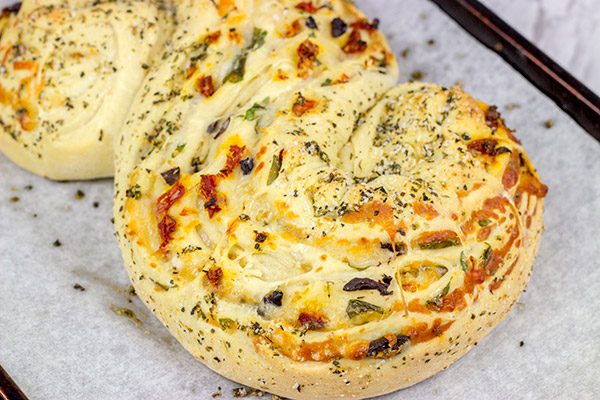 This Stuffed Italian Bread is so much fun to make...and even more fun to eat!  It's packed with mozzarella, Parmesan, sundried tomatoes and kalamata olives!