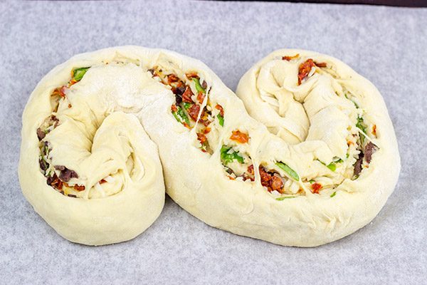 This Stuffed Italian Bread is so much fun to make...and even more fun to eat!  It's packed with mozzarella, Parmesan, sundried tomatoes and kalamata olives!