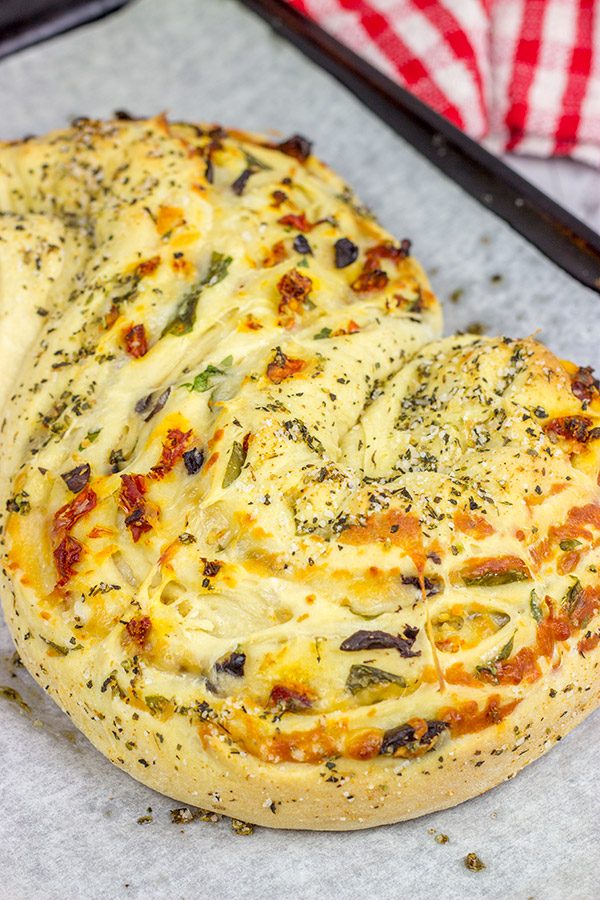 This Stuffed Italian Bread is so much fun to make...and even more fun to eat!  It's packed with mozzarella, Parmesan, sundried tomatoes and kalamata olives!