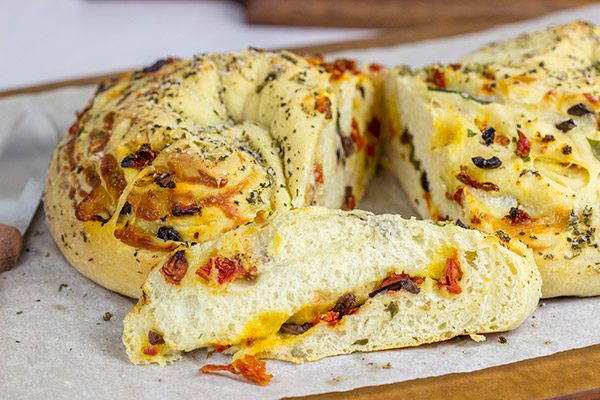 This Stuffed Italian Bread is so much fun to make...and even more fun to eat! It's packed with mozzarella, Parmesan, sundried tomatoes and kalamata olives!