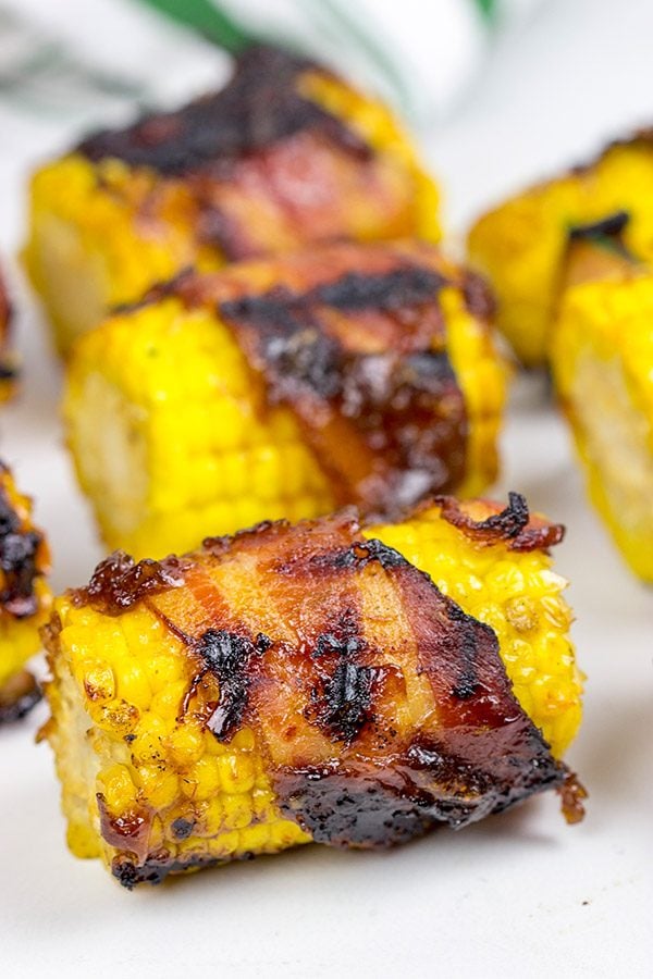 Hunting for a fun side dish for summer grilling? This Bacon Wrapped Corn with Honey BBQ Sauce is a winner!