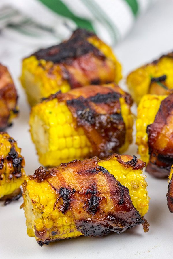 Hunting for a fun side dish for summer grilling? This Bacon Wrapped Corn with Honey BBQ Sauce is a winner!