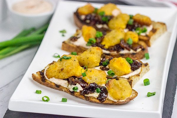 These Bacon and Cheddar Cheese Curd Bites make for a delicious appetizer...especially while watching sports!  And the smoky ranch dressing?  It's tasty enough to be a dip all by itself!