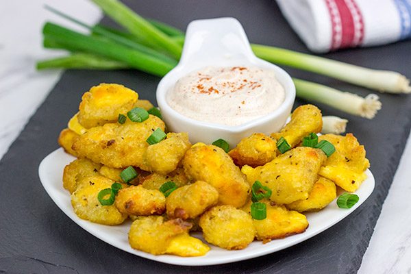 These Bacon and Cheddar Cheese Curd Bites make for a delicious appetizer...especially while watching sports!  And the smoky ranch dressing?  It's tasty enough to be a dip all by itself!