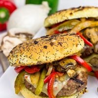 These Grilled Philly Burgers start with a tasty backyard burger and then get topped with BBQ-glazed onions, peppers and mushrooms!