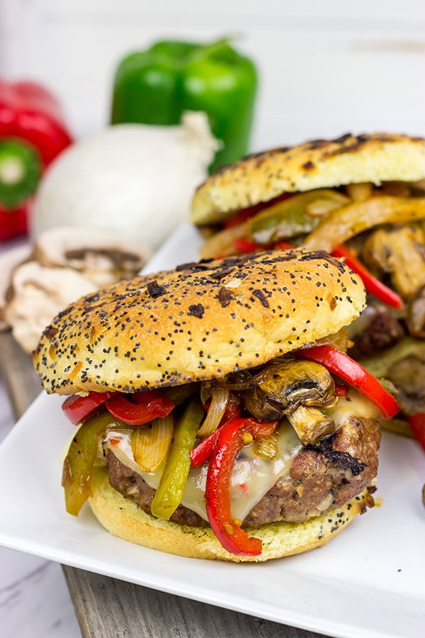 These Grilled Philly Burgers start with a tasty backyard burger and then get topped with BBQ-glazed onions, peppers and mushrooms!