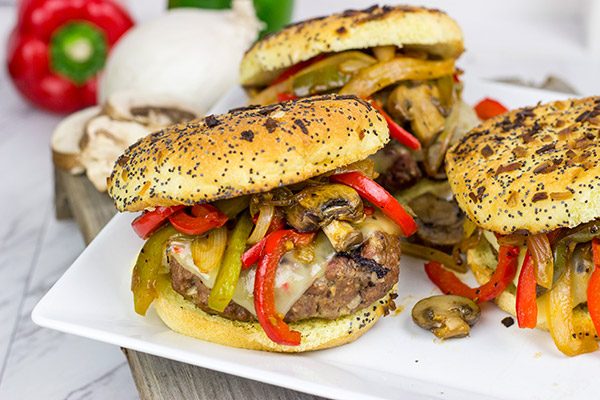 These Grilled Philly Burgers start with a tasty backyard burger and then get topped with BBQ-glazed onions, peppers and mushrooms!
