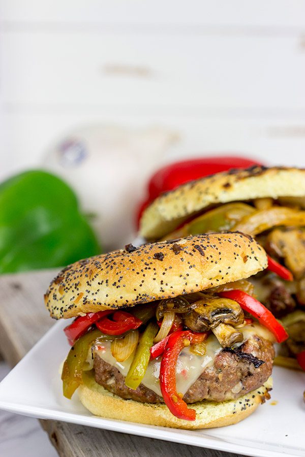 These Grilled Philly Burgers start with a tasty backyard burger and then get topped with BBQ-glazed onions, peppers and mushrooms!