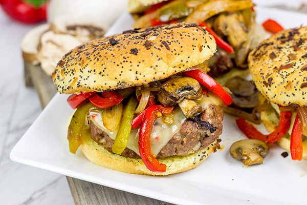 These Grilled Philly Burgers start with a tasty backyard burger and then get topped with BBQ-glazed onions, peppers and mushrooms!