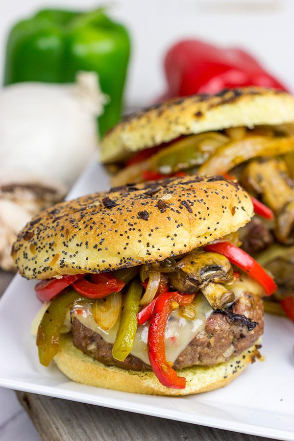These Grilled Philly Burgers start with a tasty backyard burger and then get topped with BBQ-glazed onions, peppers and mushrooms!