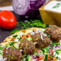 These Mediterranean Meatball Kabobs deserve a spot on your dinner menu soon! Served up with grilled naan and a bit of tzatziki sauce, these meatballs are sure to become a favorite in your house, too!