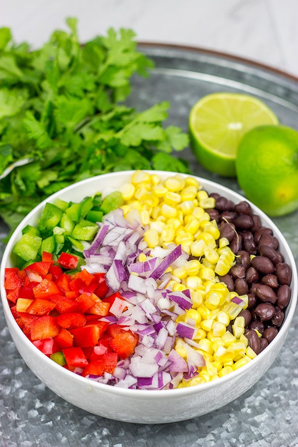 This Easy Black Bean Salad is a summer staple in our house.  It's delicious as either a side dish with grilled food or as a dip with tortilla chips!