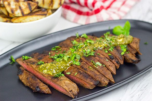 The flat iron steak is the 2nd most tender cut of beef behind only a tenderloin (aka "filet mignon").  Give the flat iron cut a shot with this Marinated Flat Iron Steak with Pesto Butter recipe!