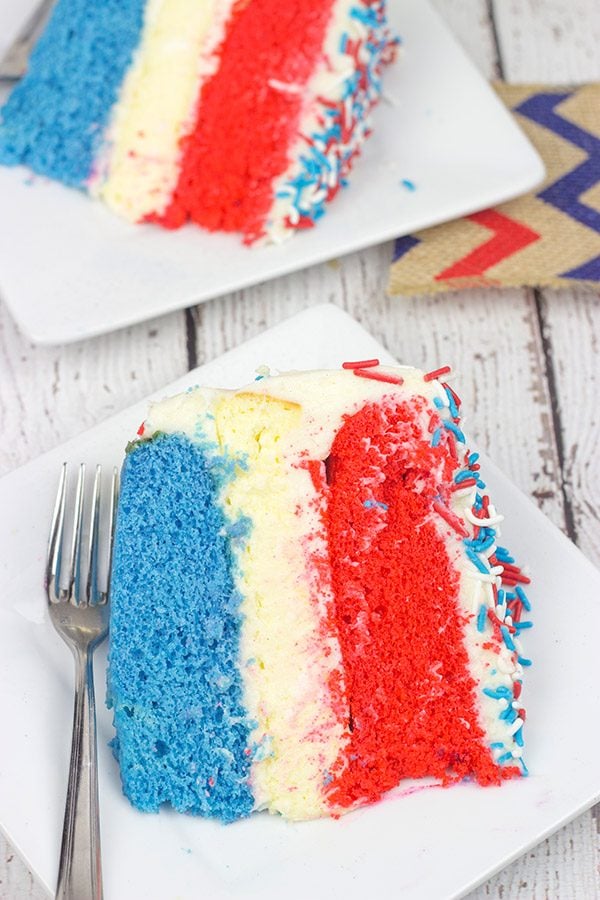 Celebrate summer and the 4th of July with a slice of this Red White and Blue Cheesecake Cake!