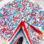 Celebrate summer and the 4th of July with a slice of this Red White and Blue Cheesecake Cake!