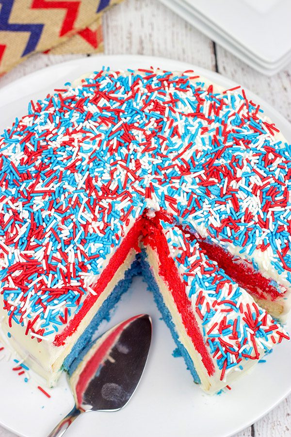 Celebrate summer and the 4th of July with a slice of this Red White and Blue Cheesecake Cake!