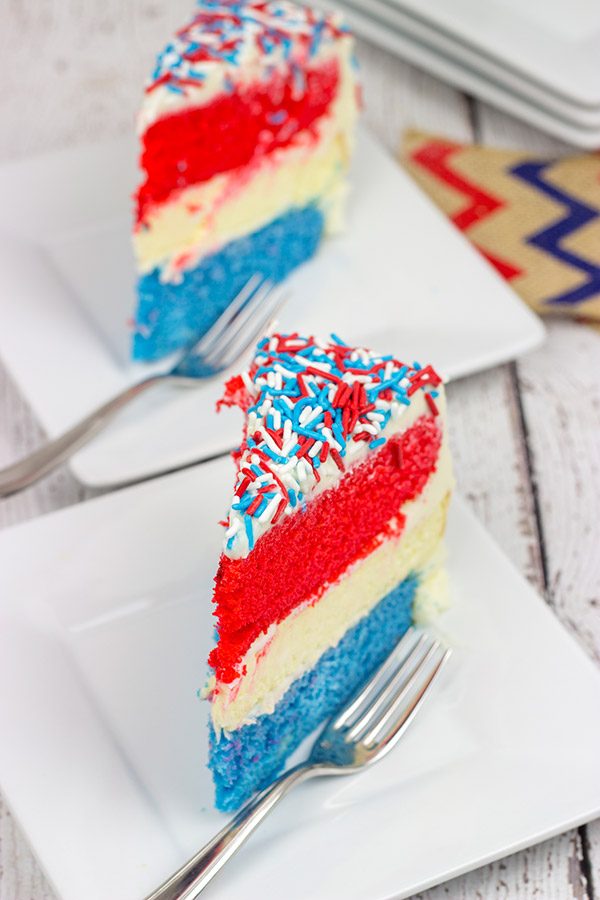 Celebrate summer and the 4th of July with a slice of this Red White and Blue Cheesecake Cake!