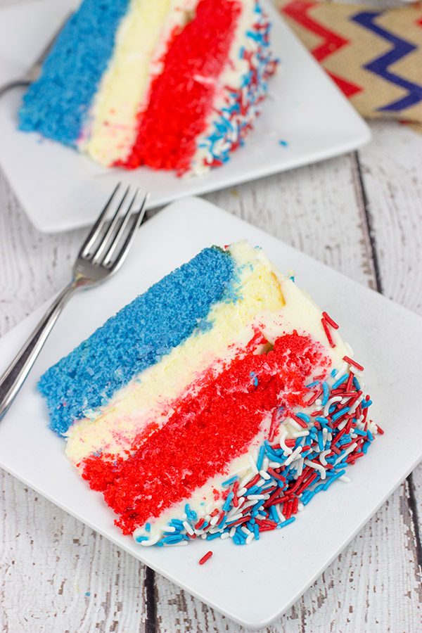Celebrate summer and the 4th of July with a slice of this Red White and Blue Cheesecake Cake!
