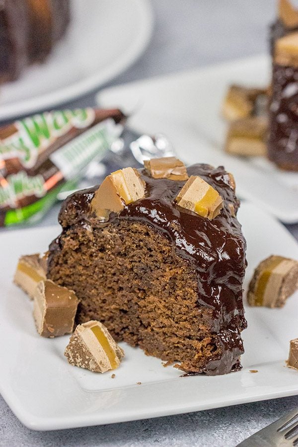 This Milky Way Bundt Cake features Milky Way candy bars baked in the cake and sprinkled on top.  It's the perfect dessert for the chocolate lover in your life!