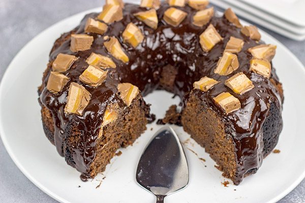 This Milky Way Bundt Cake features Milky Way candy bars baked in the cake and sprinkled on top.  It's the perfect dessert for the chocolate lover in your life!