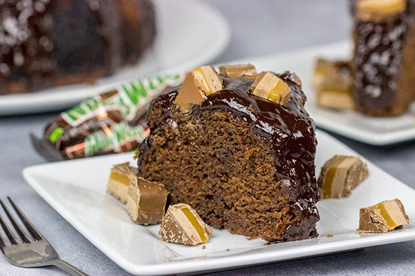 This Milky Way Bundt Cake features Milky Way candy bars baked in the cake and sprinkled on top.  It's the perfect dessert for the chocolate lover in your life!