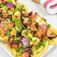 Served over pasta with a bit of grated Parmesan cheese, these Grilled Blackened Chicken Kabobs make for a tasty summer meal!