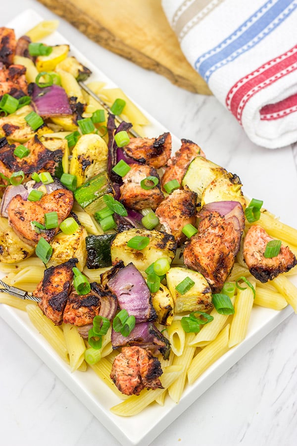 Served over pasta with a bit of grated Parmesan cheese, these Grilled Blackened Chicken Kabobs make for a tasty summer meal!