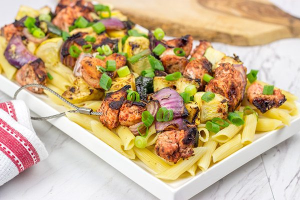 Served over pasta with a bit of grated Parmesan cheese, these Grilled Blackened Chicken Kabobs make for a tasty summer meal!