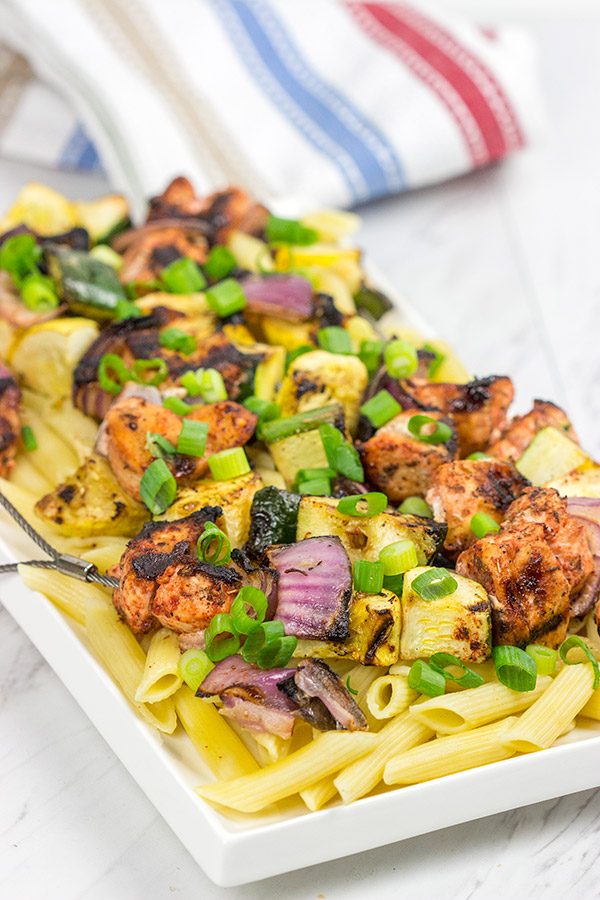 Served over pasta with a bit of grated Parmesan cheese, these Grilled Blackened Chicken Kabobs make for a tasty summer meal!
