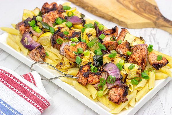 Served over pasta with a bit of grated Parmesan cheese, these Grilled Blackened Chicken Kabobs make for a tasty summer meal!