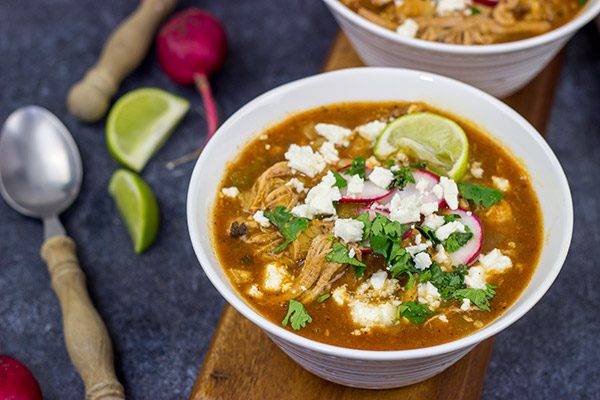 Slow Cooker Pork Posole is an easy dish to make on chilly Fall and Winter days.  It's packed with shredded pork and traditional Mexican flavors for a hearty and delicious meal!